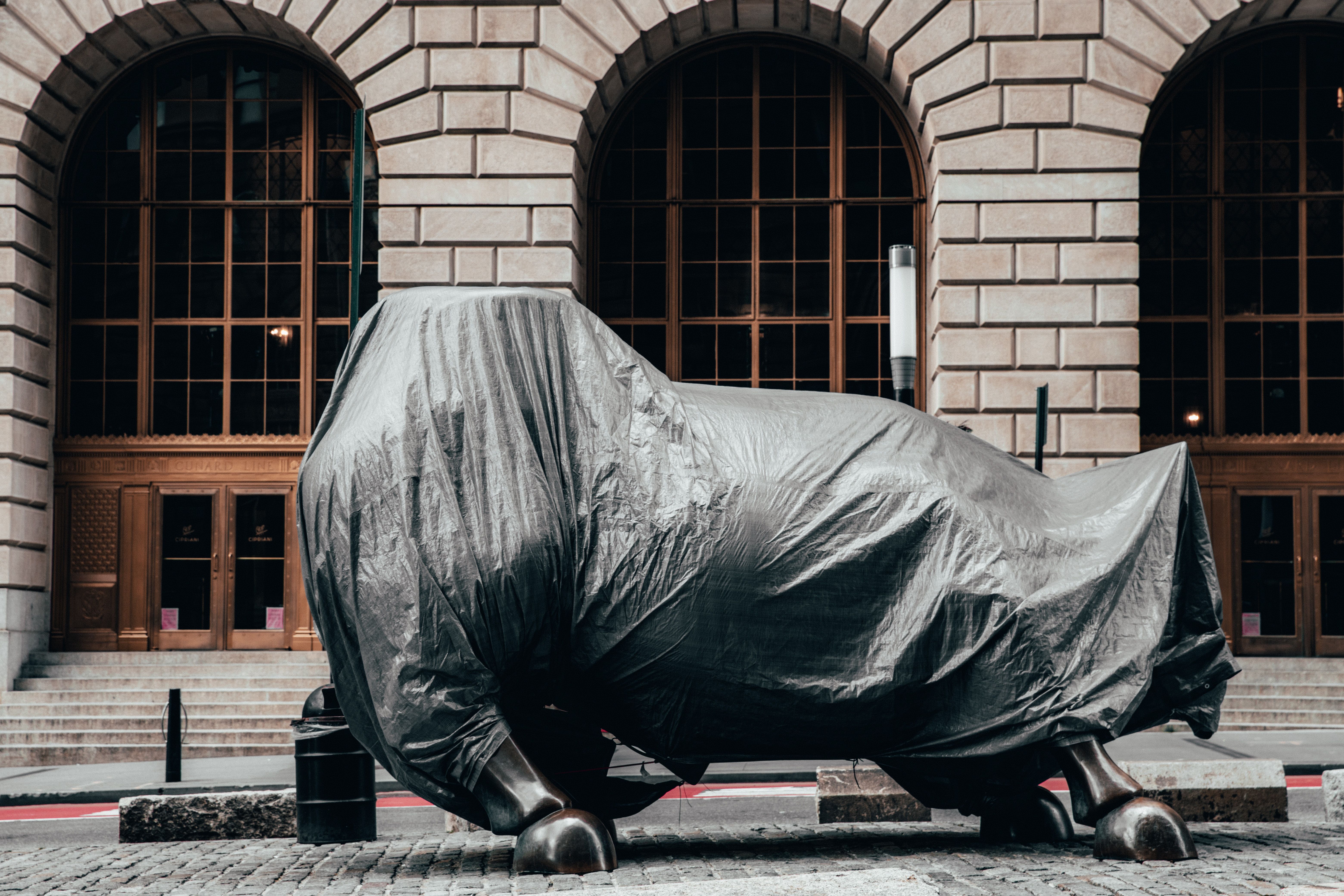 Covered Charging Bull statue on Wall Street symbolizing market power and volatility