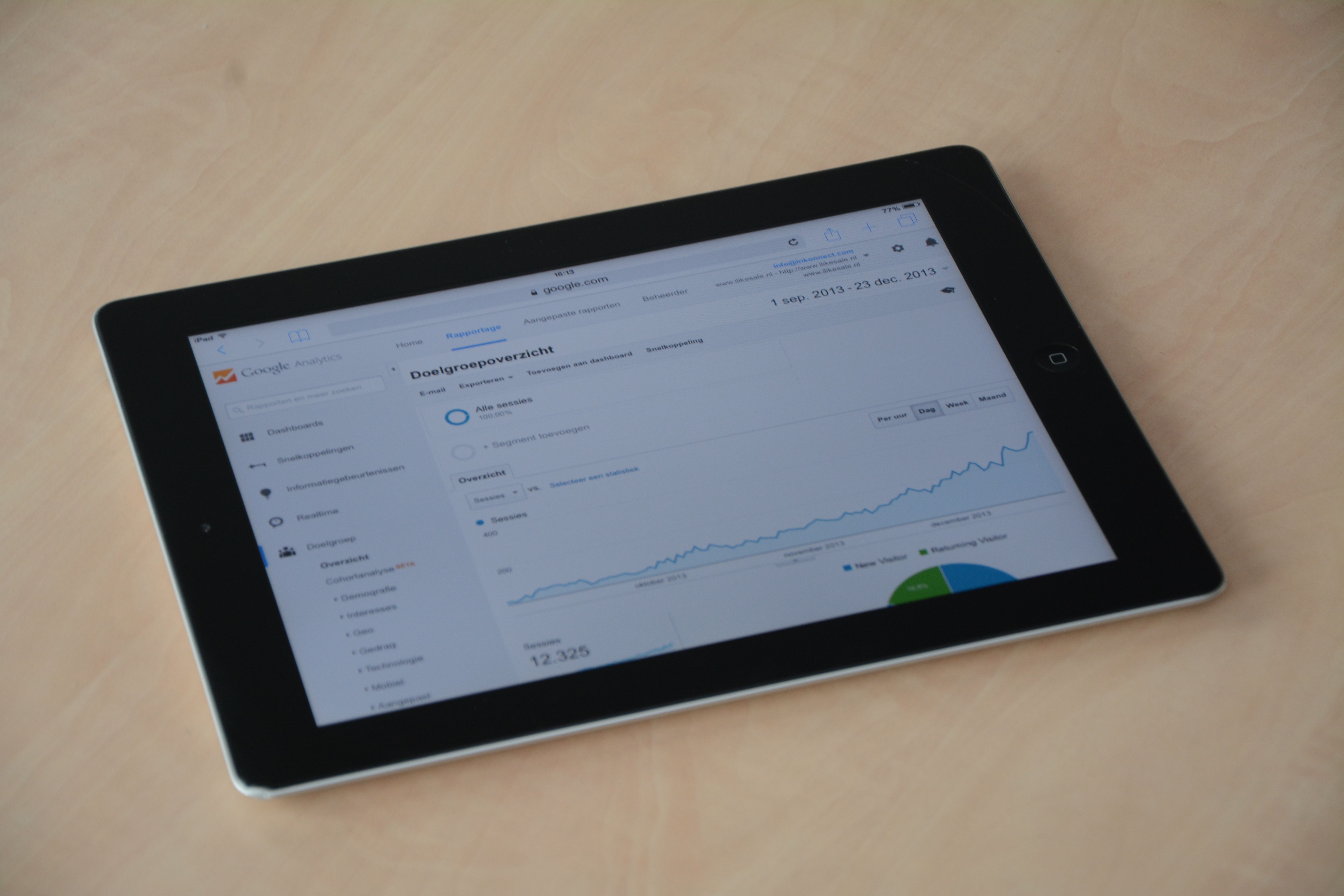 Digital tablet showing a web analytics dashboard with graphs and charts used to measure SEO performance