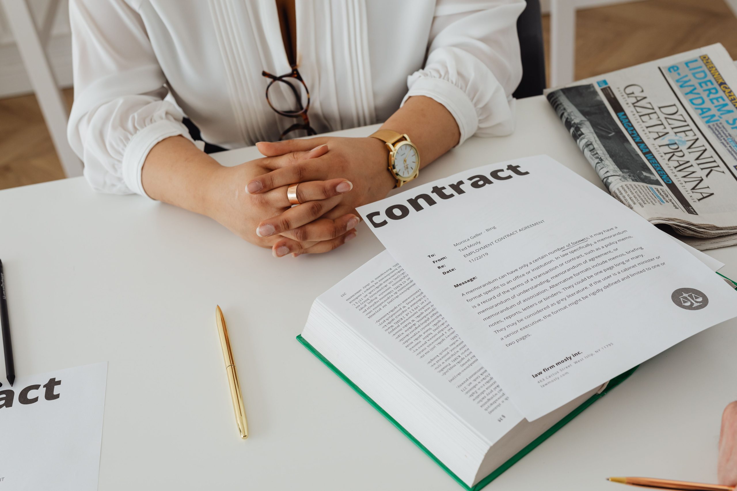 Businesswoman reviewing a legal contract and case documents at her desk